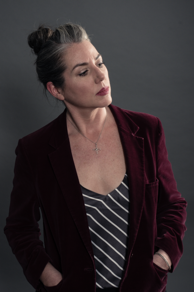 Shawna Bigby Davis in a red blazer looking pensive