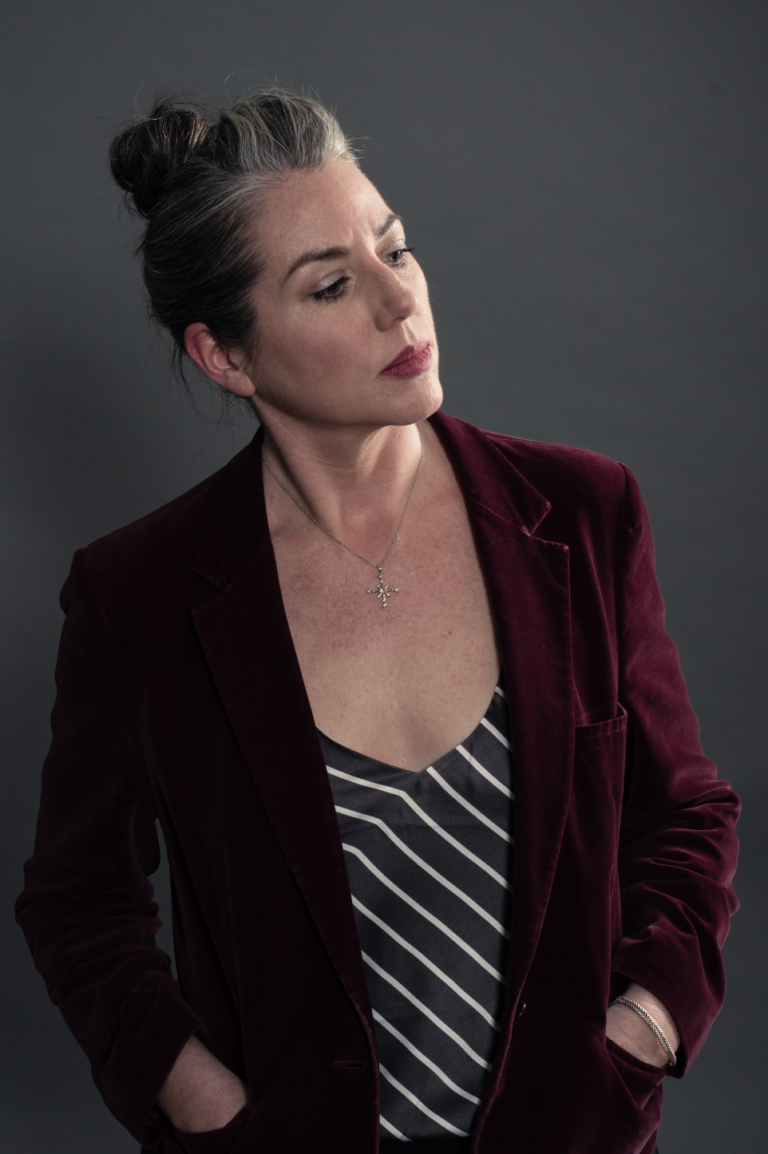 Shawna Bigby Davis in a red blazer looking pensive