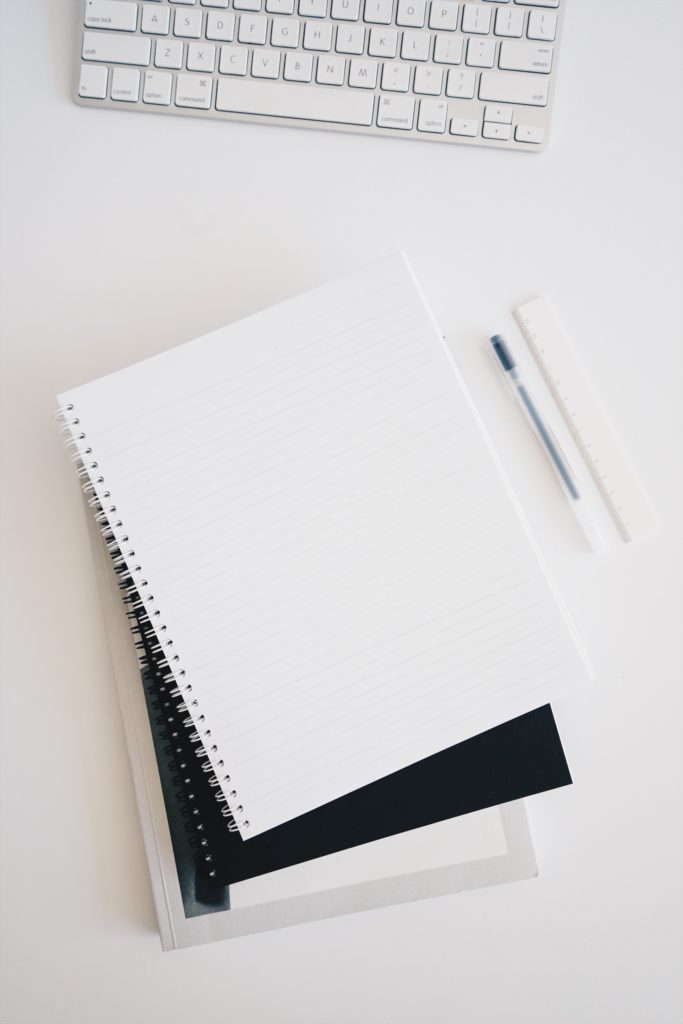 Notebooks and pen at a desk
