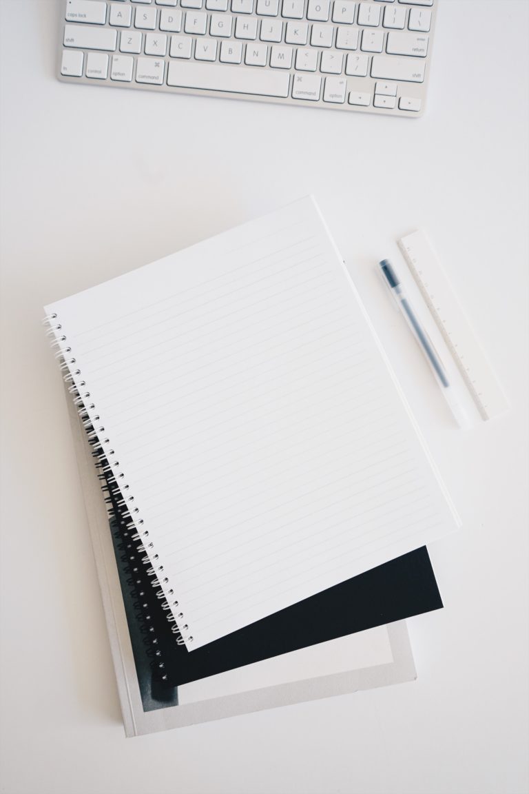 Notebooks and pen at a desk