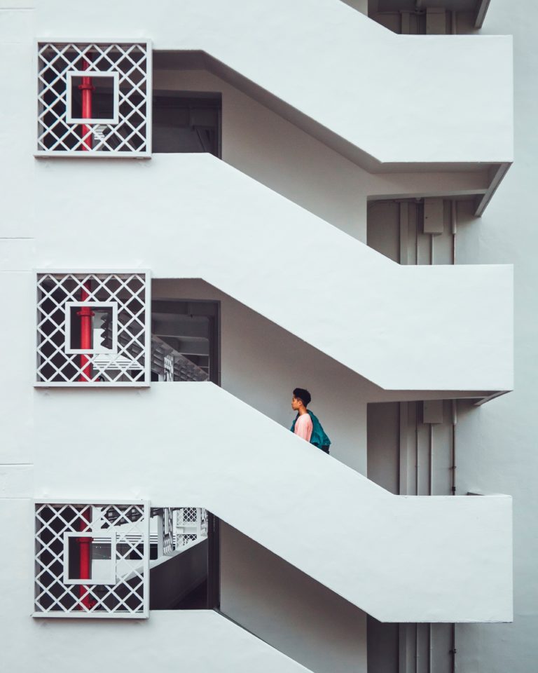 Man walking up a set of repetitive stairs